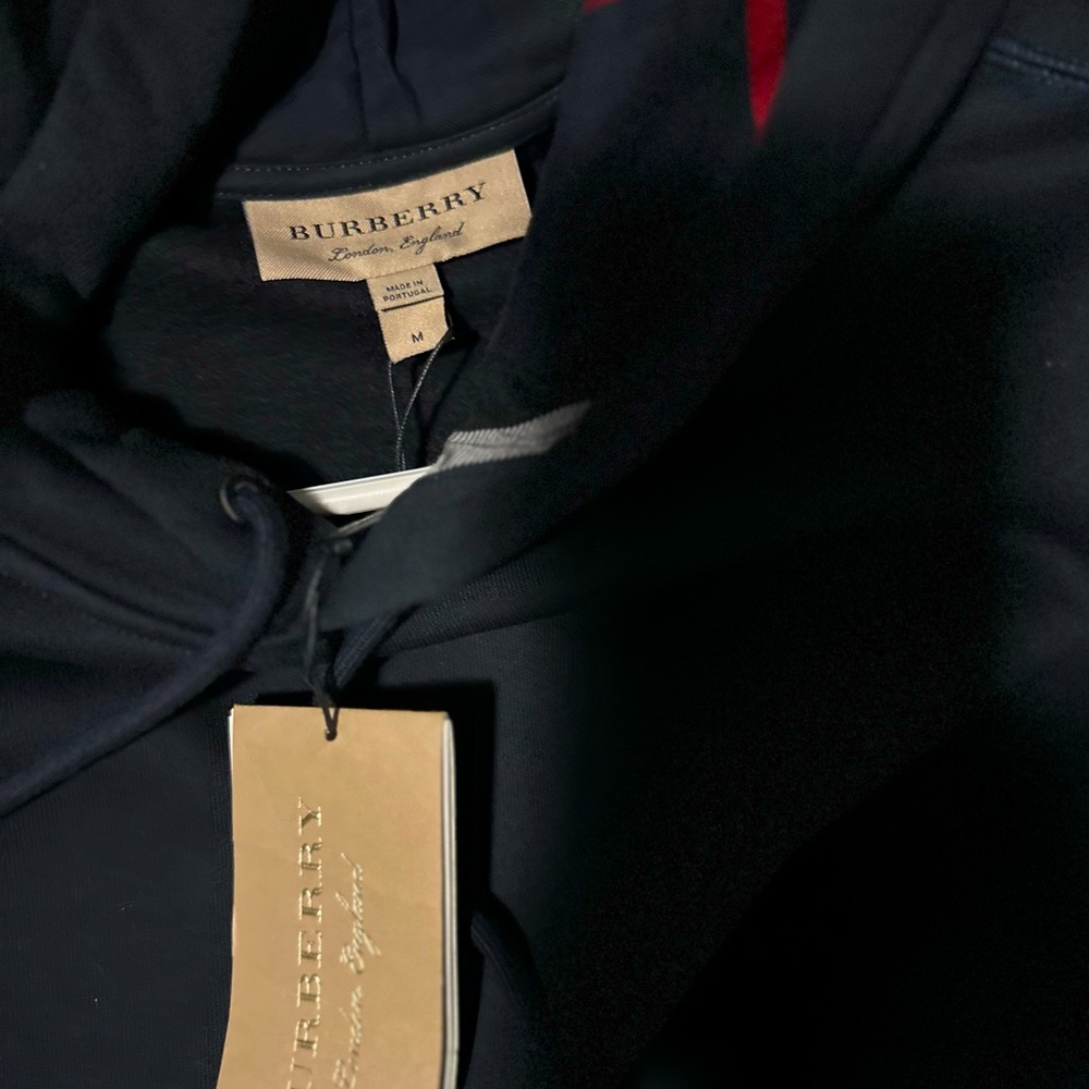 It is new with tags,it is navy blue and comes with a hat